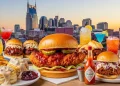 Colorful Nashville food collage featuring hot chicken, biscuits, BBQ, cocktails, and skyline in the background