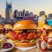 Colorful Nashville food collage featuring hot chicken, biscuits, BBQ, cocktails, and skyline in the background