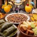Colorful table full of traditional Nicaraguan food including gallo pinto, nacatamales wrapped in banana leaves, vigoron, fried plantains, tropical drinks, rustic wooden table, vibrant Latin American street food scene, natural lighting
