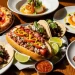 “Phoenix Arizona food collage, Sonoran hot dog, tacos, fine dining dish, pizza, steak, vibrant colors, editorial magazine style, high detail” rustic table, natural light, authentic food photography